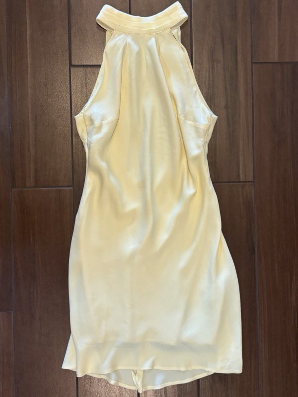 Pale cream satin halter dress laid out after alteration